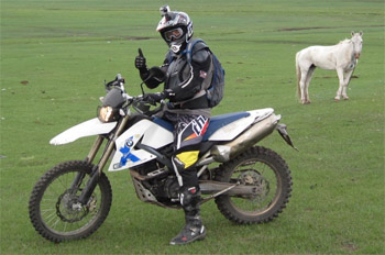 Custom made tour is the best! man on motorcycle in Mongolia desert